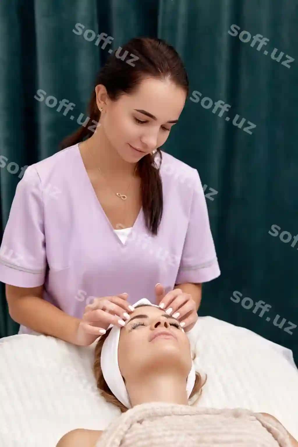 Ayol bekat salonida yuz massajsi davolash olayotgan. | Woman getting face massage treatment beauty salon